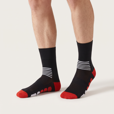 Six Stripe mid-length cycling socks on feet, front view, black with white stripes and a red heel and toe